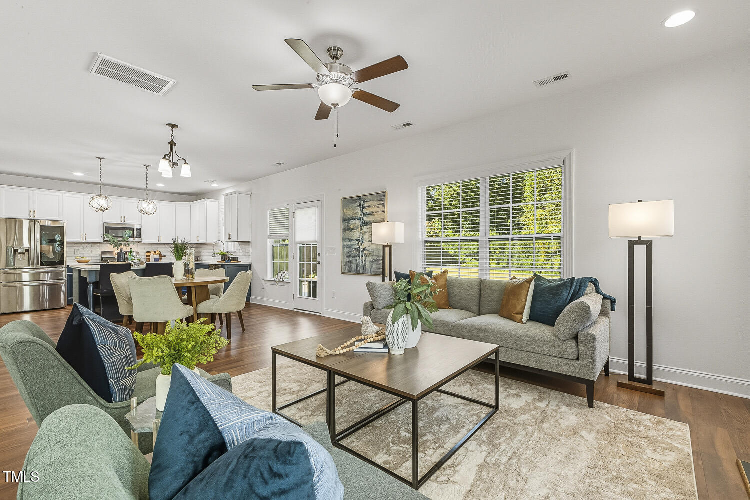5180 Copain Cove Fuquay-Varina, NC 27526 - Photo 7 of 45 a living room with furniture kitchen area and a large window