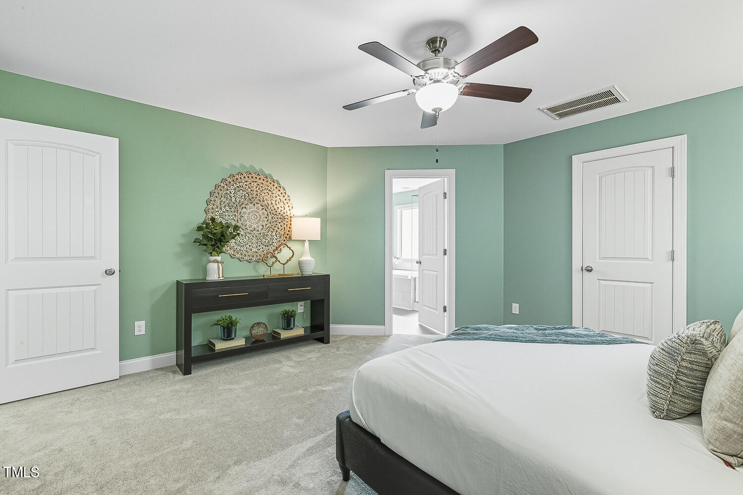 5180 Copain Cove Fuquay-Varina, NC 27526 - Photo 21 of 45 a bedroom with a bed and a chandelier