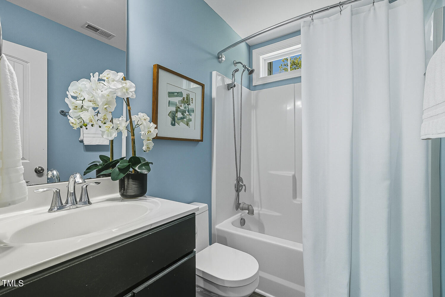 5180 Copain Cove Fuquay-Varina, NC 27526 - Photo 27 of 45 a bathroom with a sink a toilet and shower