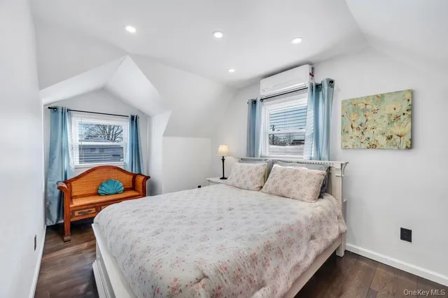 a bedroom with a bed and painting on the wall