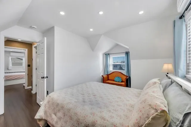 a bedroom with a bed and a large window