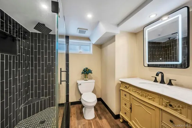 a bathroom with a toilet sink and shower