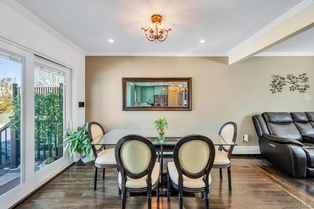 a bathroom with a toilet a sink a mirror and a window