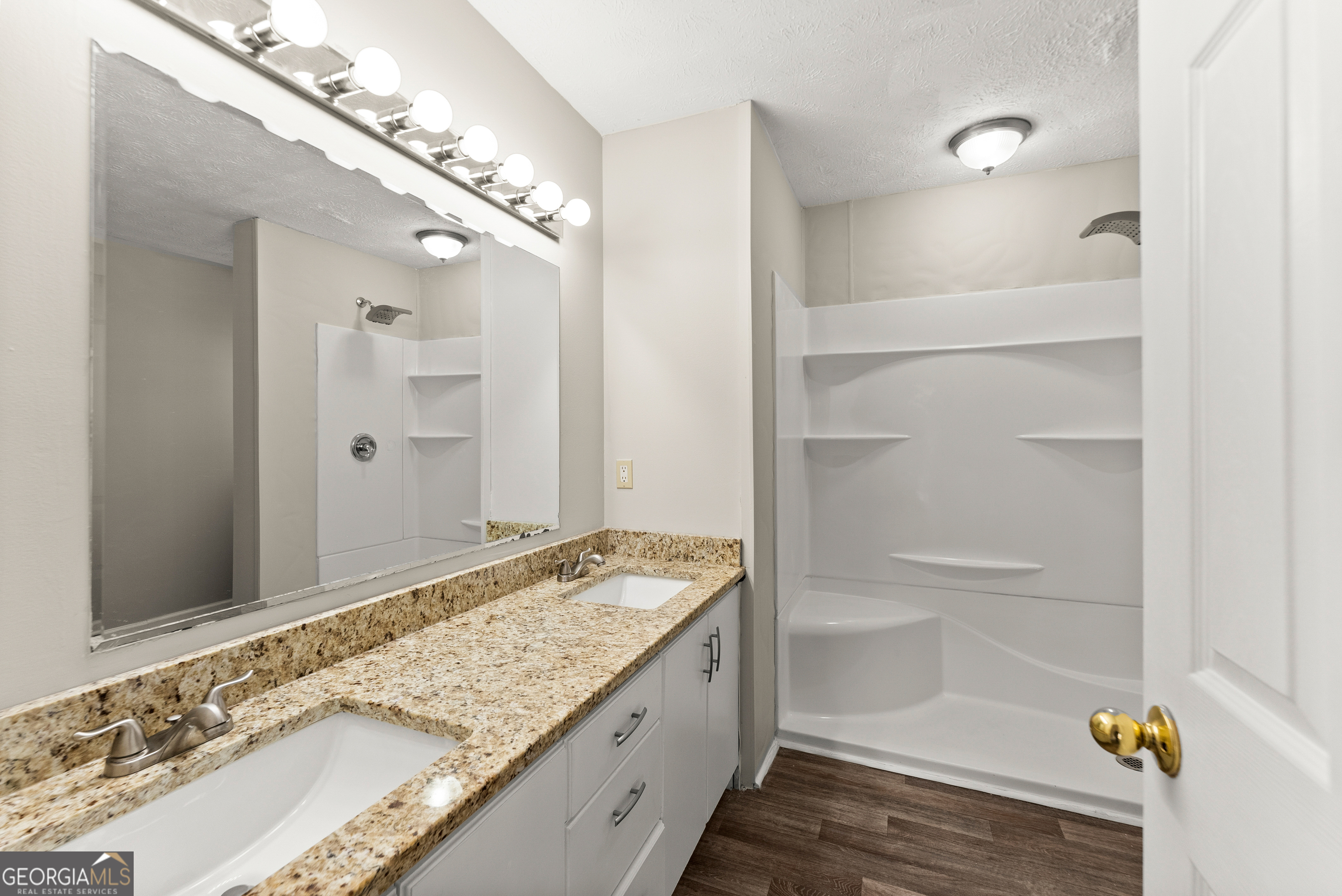 5011 Weaver Road Gainesville, GA 30507 - Photo 23 of 62 a bathroom with a granite countertop sink and a mirror