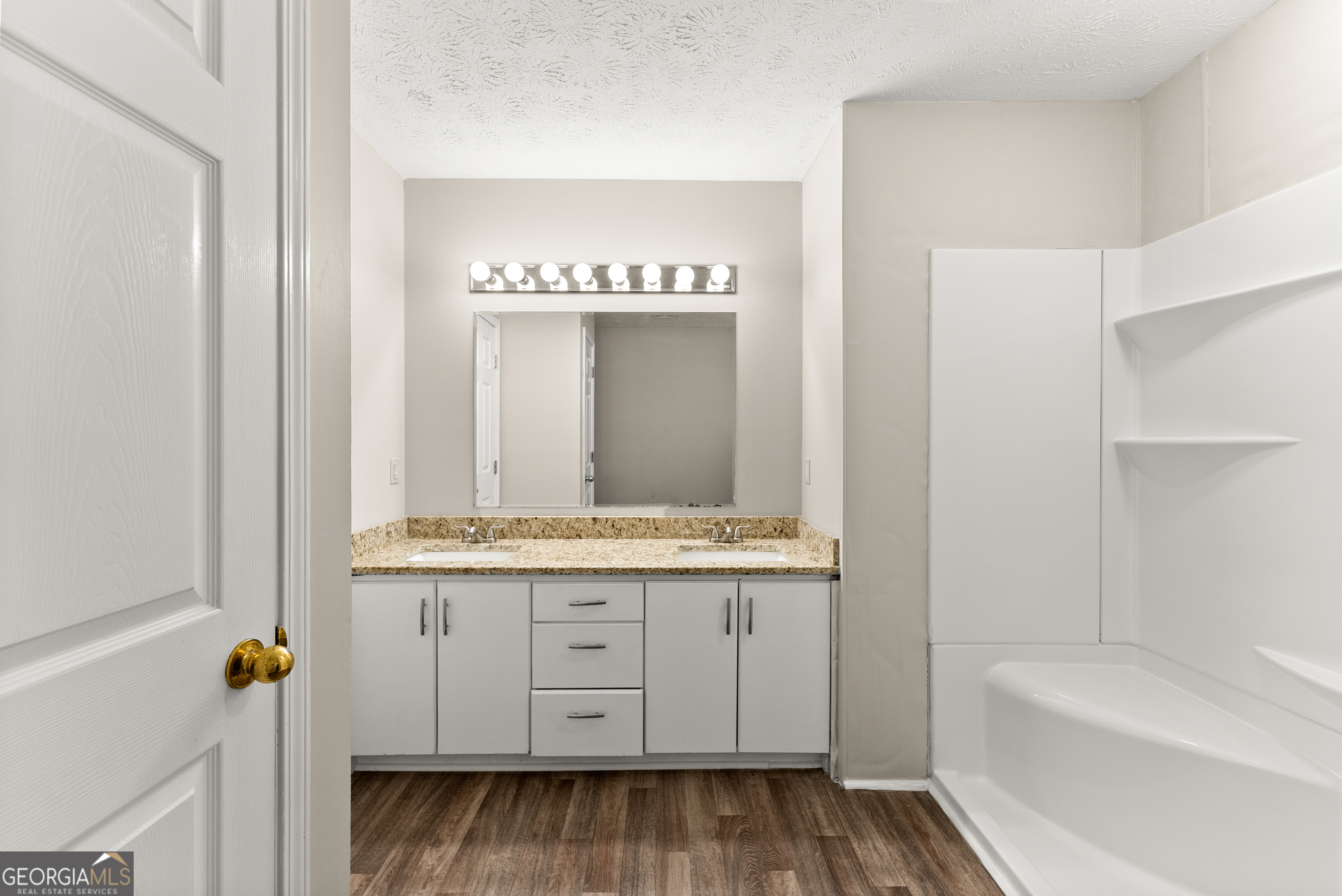 5011 Weaver Road Gainesville, GA 30507 - Photo 24 of 62 a spacious bathroom with a granite countertop sink a mirror and a bathtub