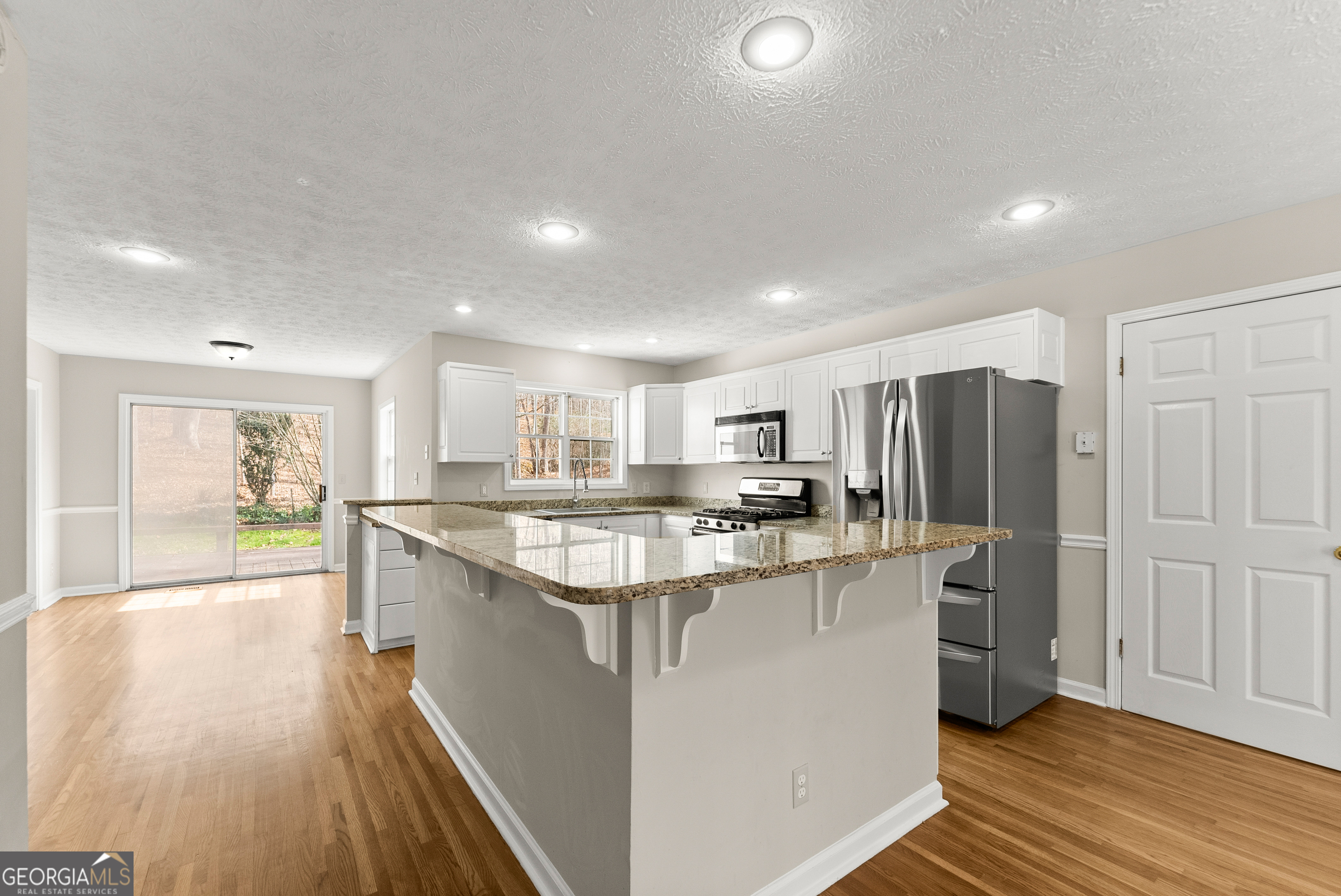 5011 Weaver Road Gainesville, GA 30507 - Photo 29 of 62 a kitchen with stainless steel appliances a sink stove and refrigerator