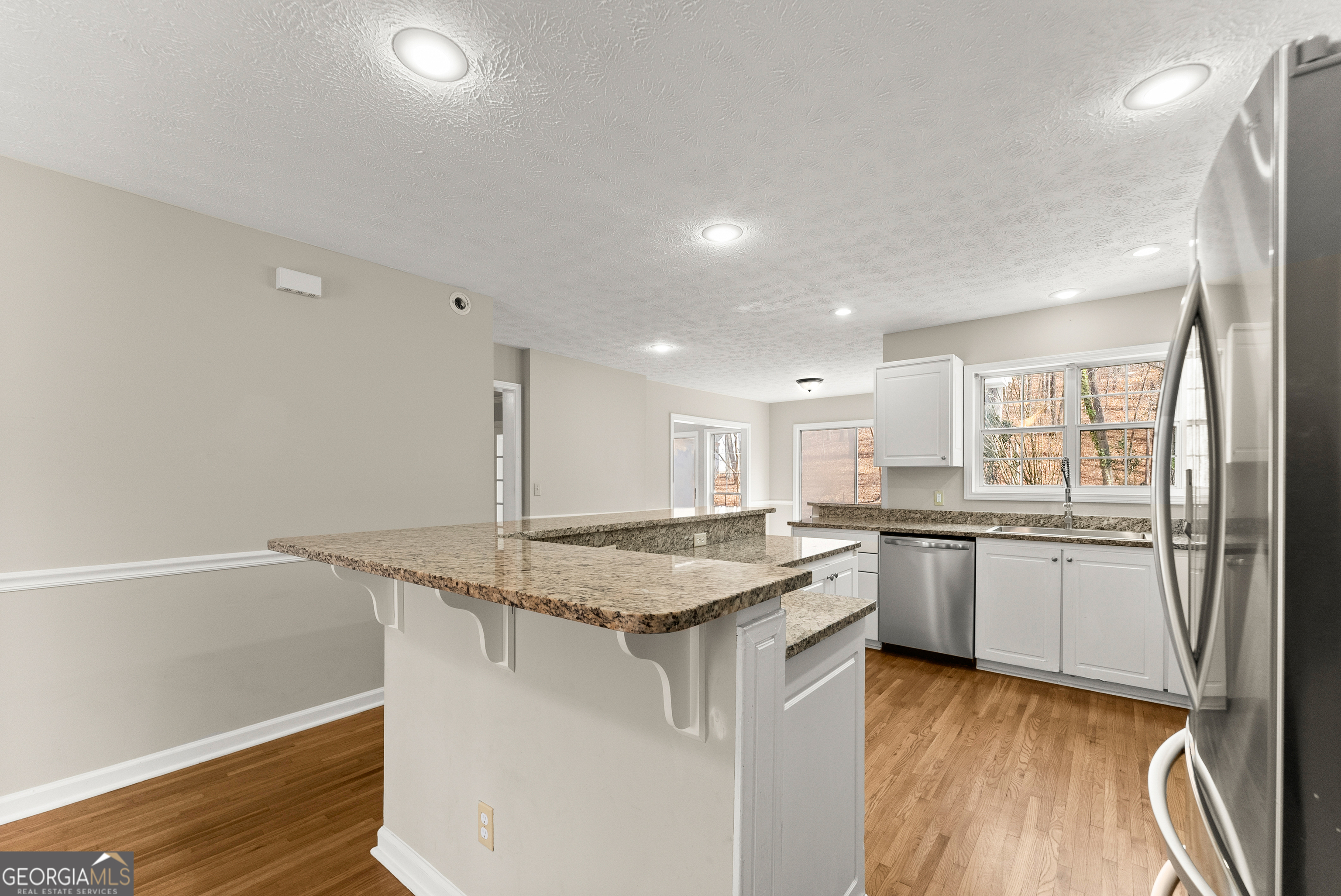 5011 Weaver Road Gainesville, GA 30507 - Photo 31 of 62 a kitchen with stainless steel appliances granite countertop a stove a sink and a refrigerator
