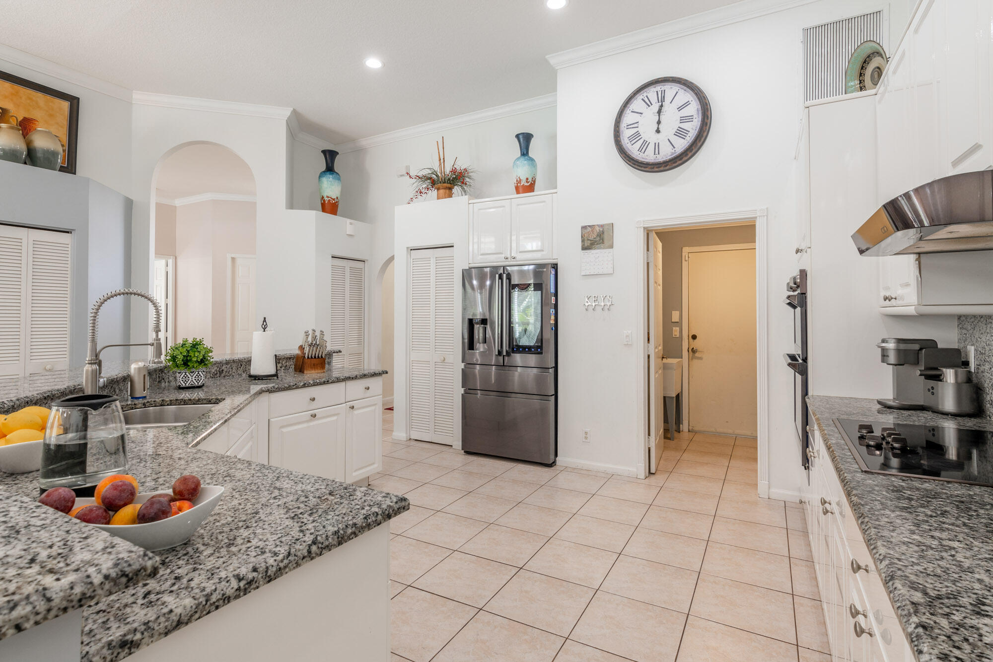 750 Cedar Cove Road Wellington, FL 33414 - Photo 12 of 37 a kitchen with stainless steel appliances granite countertop a sink and a refrigerator