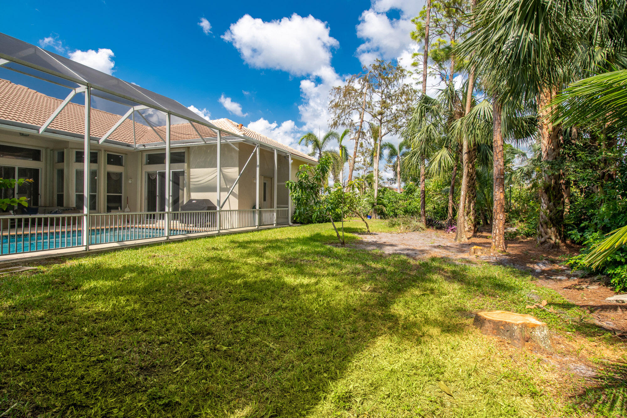 750 Cedar Cove Road Wellington, FL 33414 - Photo 31 of 37 a view of a patio with table and chairs and potted plants