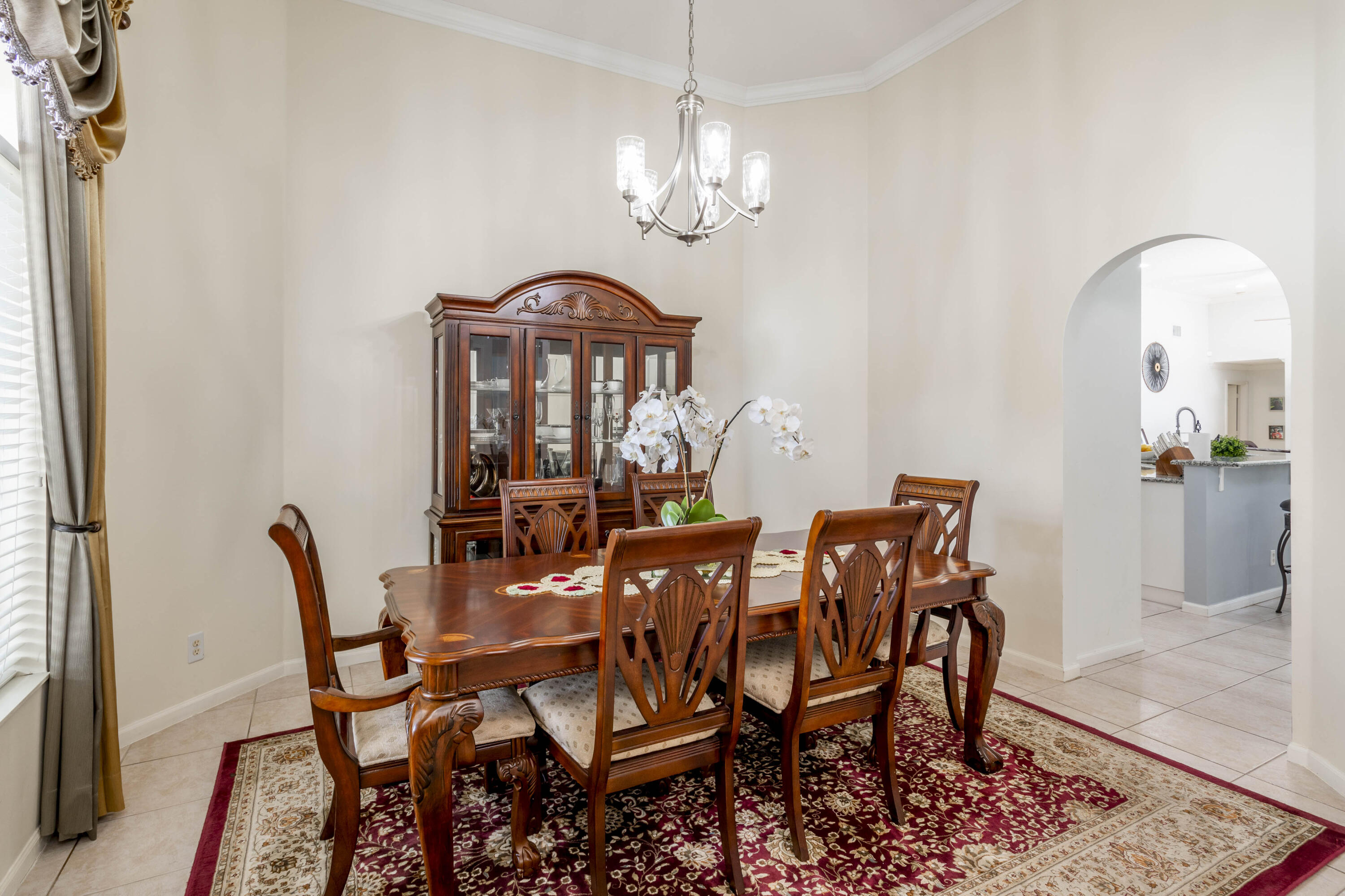 750 Cedar Cove Road Wellington, FL 33414 - Photo 8 of 37 a view of a dining room with furniture and chandelier