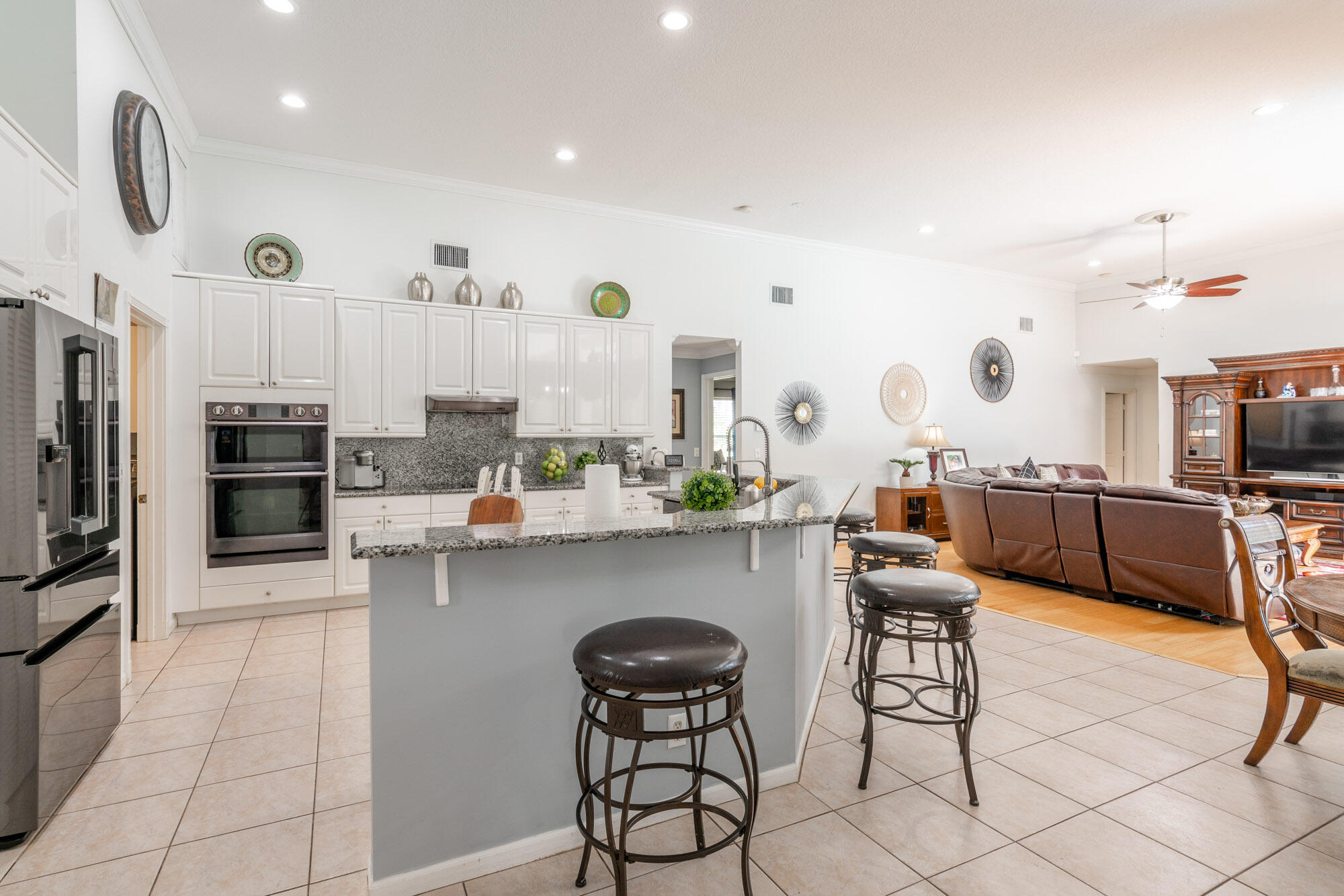 750 Cedar Cove Road Wellington, FL 33414 - Photo 9 of 37 a open kitchen with stainless steel appliances kitchen island granite countertop a sink and cabinets