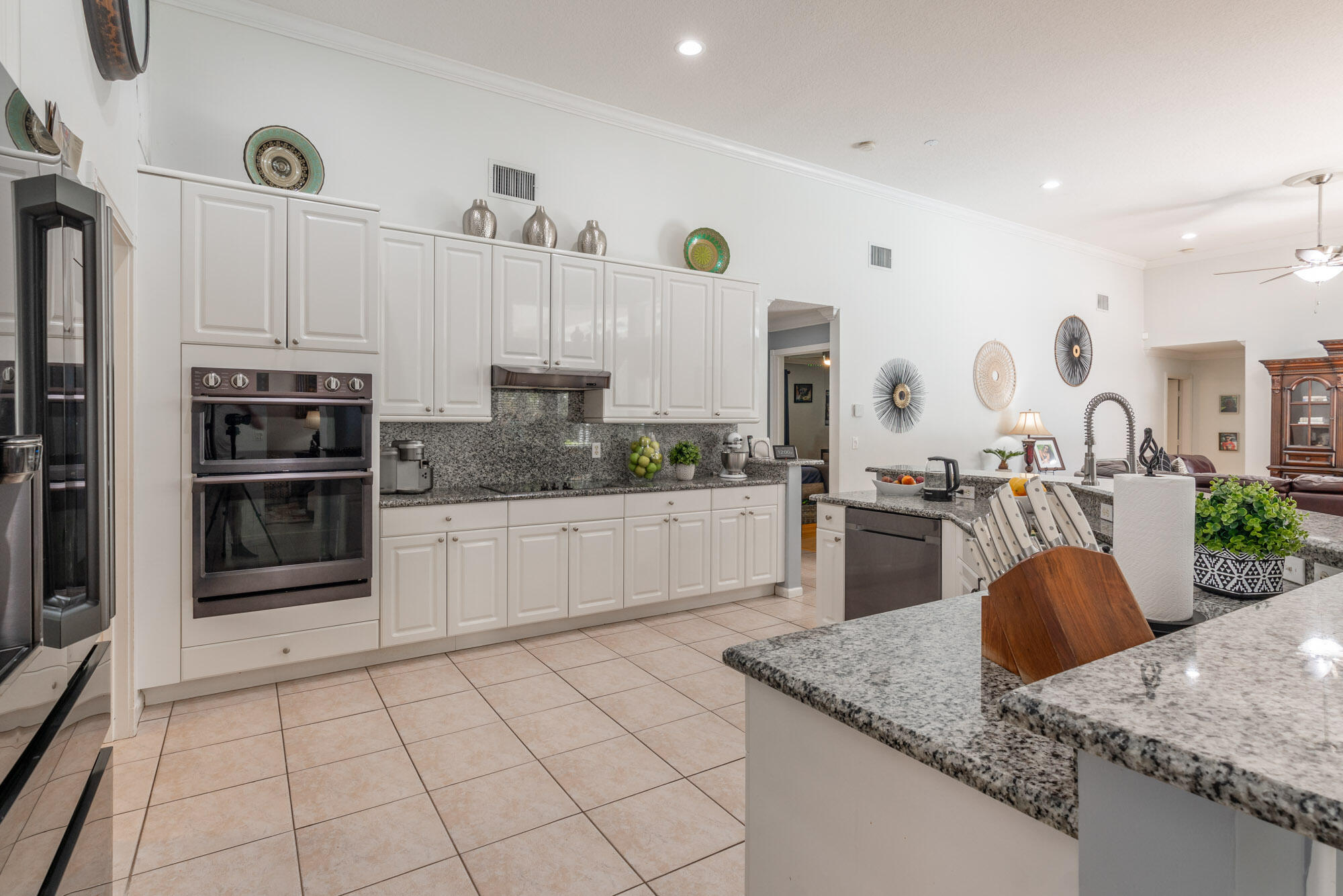 750 Cedar Cove Road Wellington, FL 33414 - Photo 10 of 37 a kitchen with stainless steel appliances granite countertop a sink stove and refrigerator