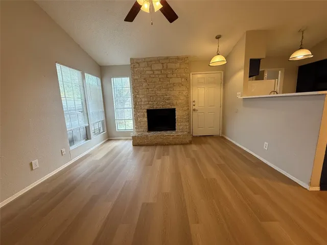 wooden floor fireplace and natural light in room