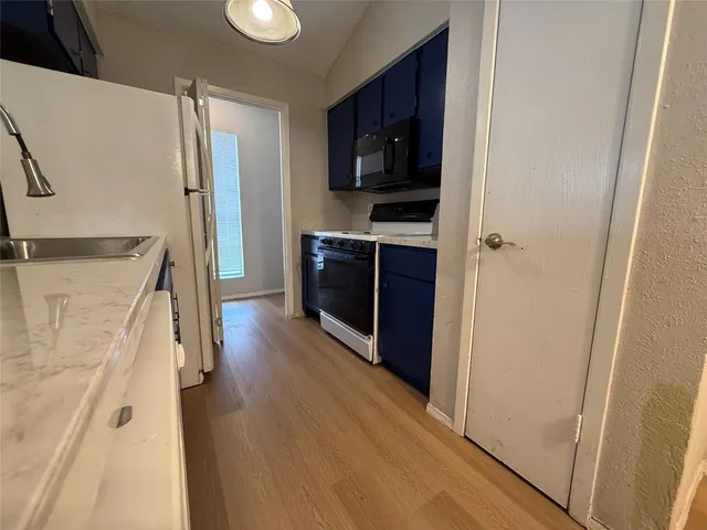 a kitchen with stainless steel appliances a refrigerator and a stove top oven