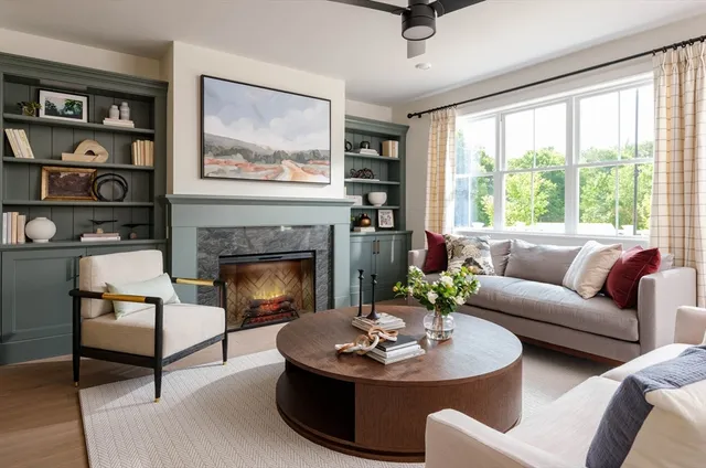 a living room with furniture and a fireplace