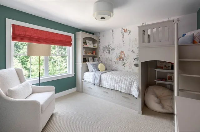 a bedroom with furniture and a large window