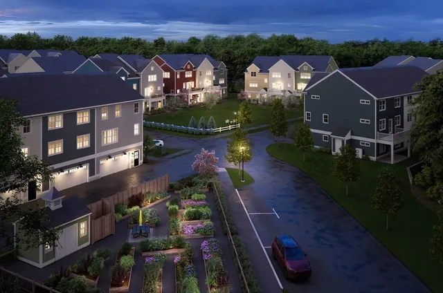 an aerial view of multiple houses with a yard