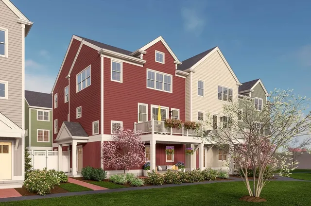 a front view of residential houses with yard and green space