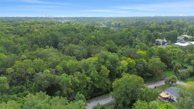 an aerial view of residential houses with outdoor and green space