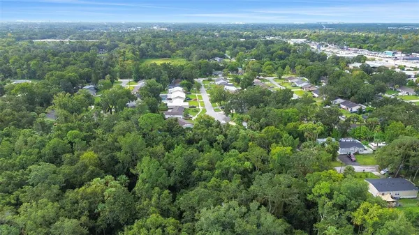 an aerial view of a city with lots of residential buildings and mountain view