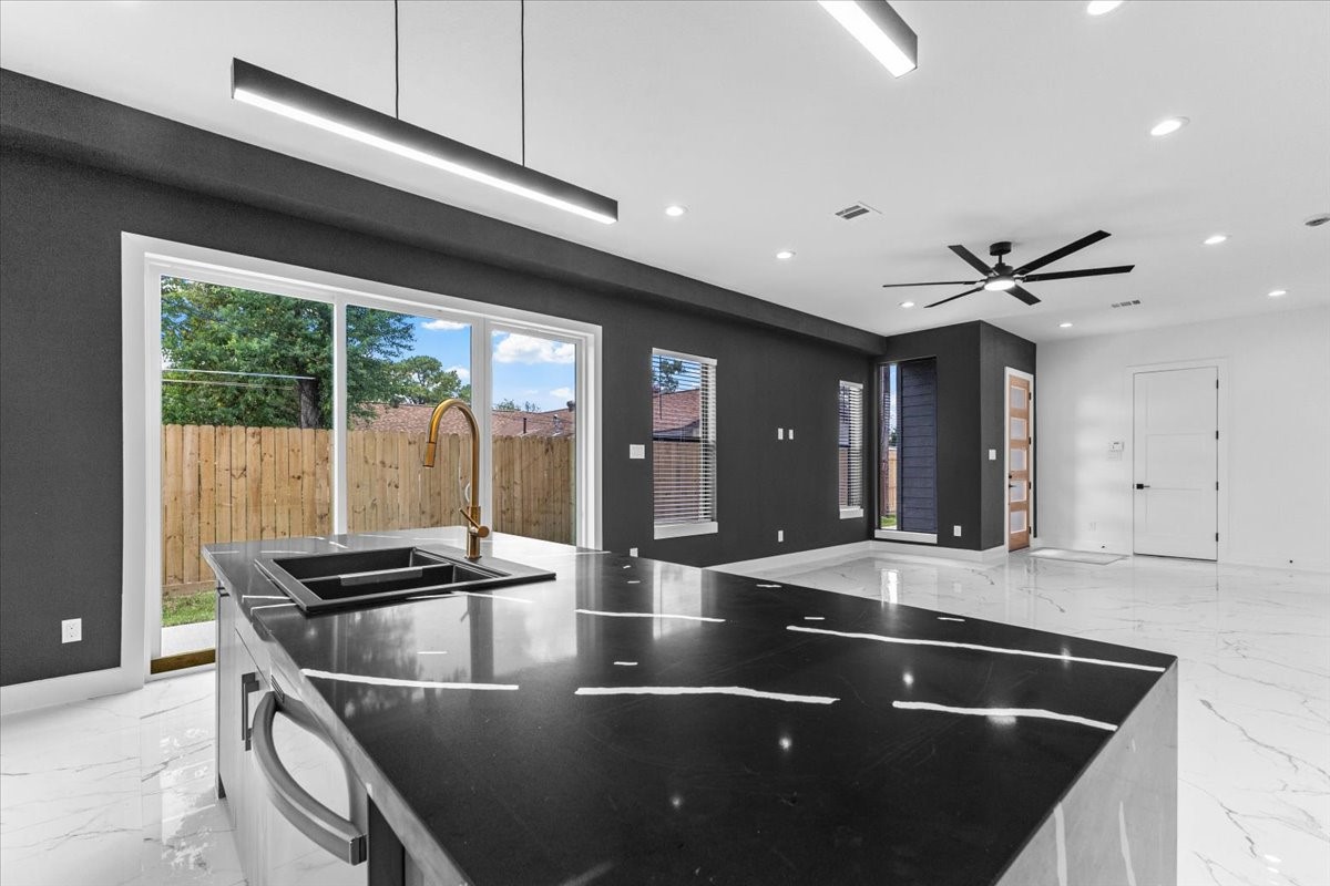 5110 Longmeadow Street, Unit B Houston, TX 77033 - Photo 11 of 25 a kitchen with stainless steel appliances granite countertop a sink and a stove
