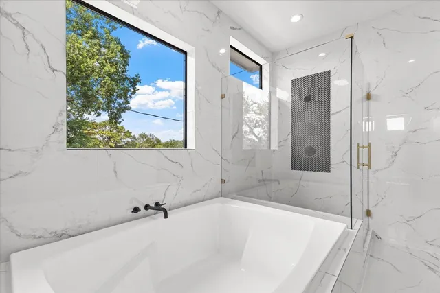 an empty room with windows and ceiling fan