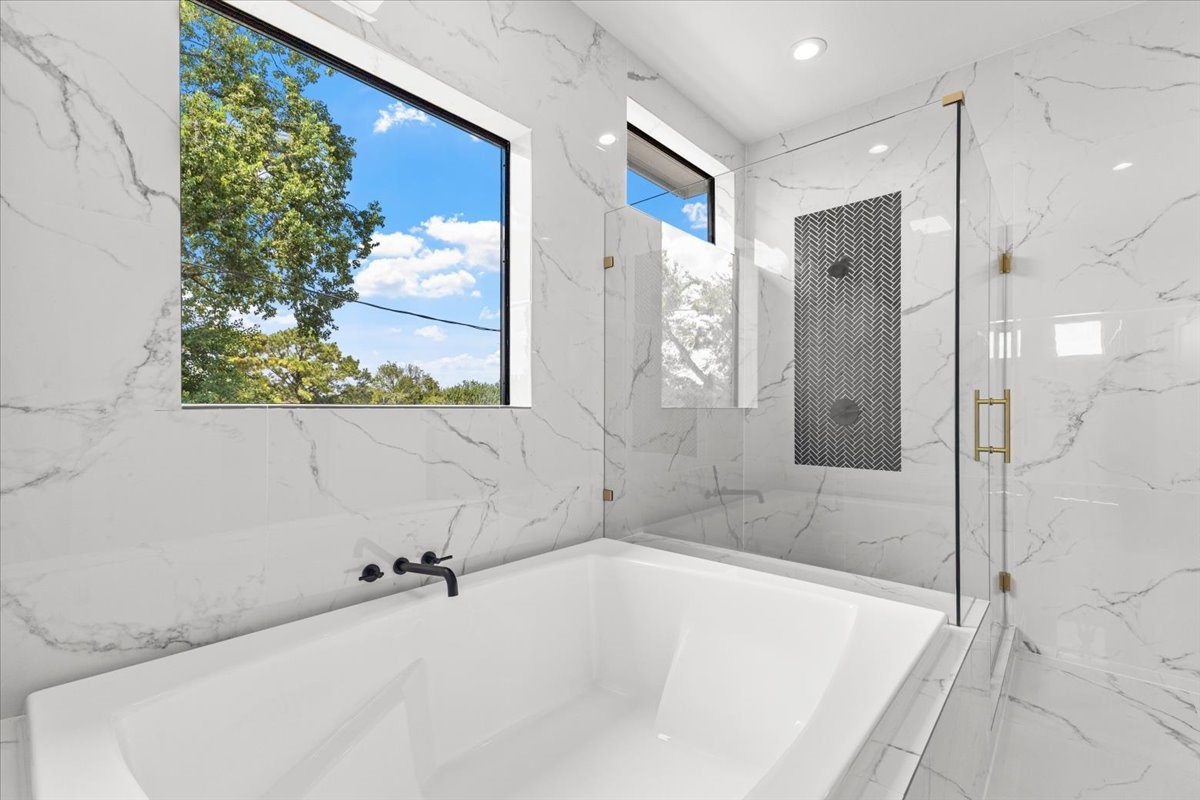 5110 Longmeadow Street, Unit B Houston, TX 77033 - Photo 19 of 25 a bathroom with a bathtub and a shower