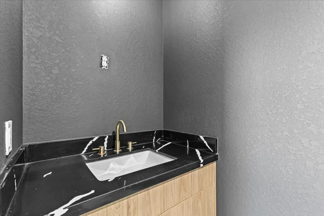 a white toilet sitting next to a white cabinet