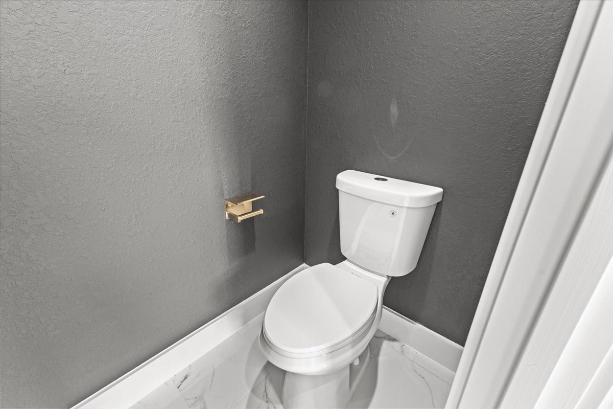 5110 Longmeadow Street, Unit B Houston, TX 77033 - Photo 25 of 25 a white toilet sitting next to a white cabinet