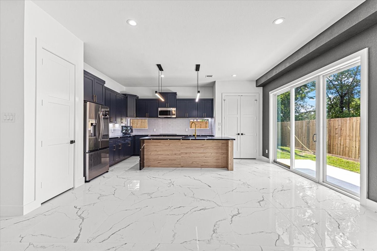 5110 Longmeadow Street, Unit B Houston, TX 77033 - Photo 5 of 25 a view of kitchen with refrigerator cabinets and furniture