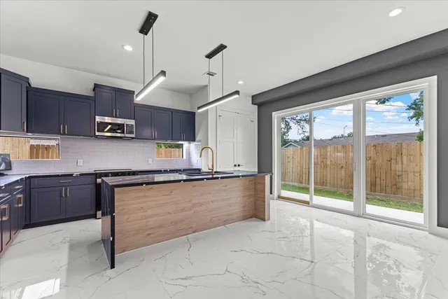 a large hall with a large window and chandelier