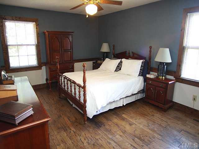 6600 Ten-Ten Road Apex, NC 27539 - Photo 13 of 25 Master bedroom features beautiful hardwood flooring and ceiling fan. Master Bedroom