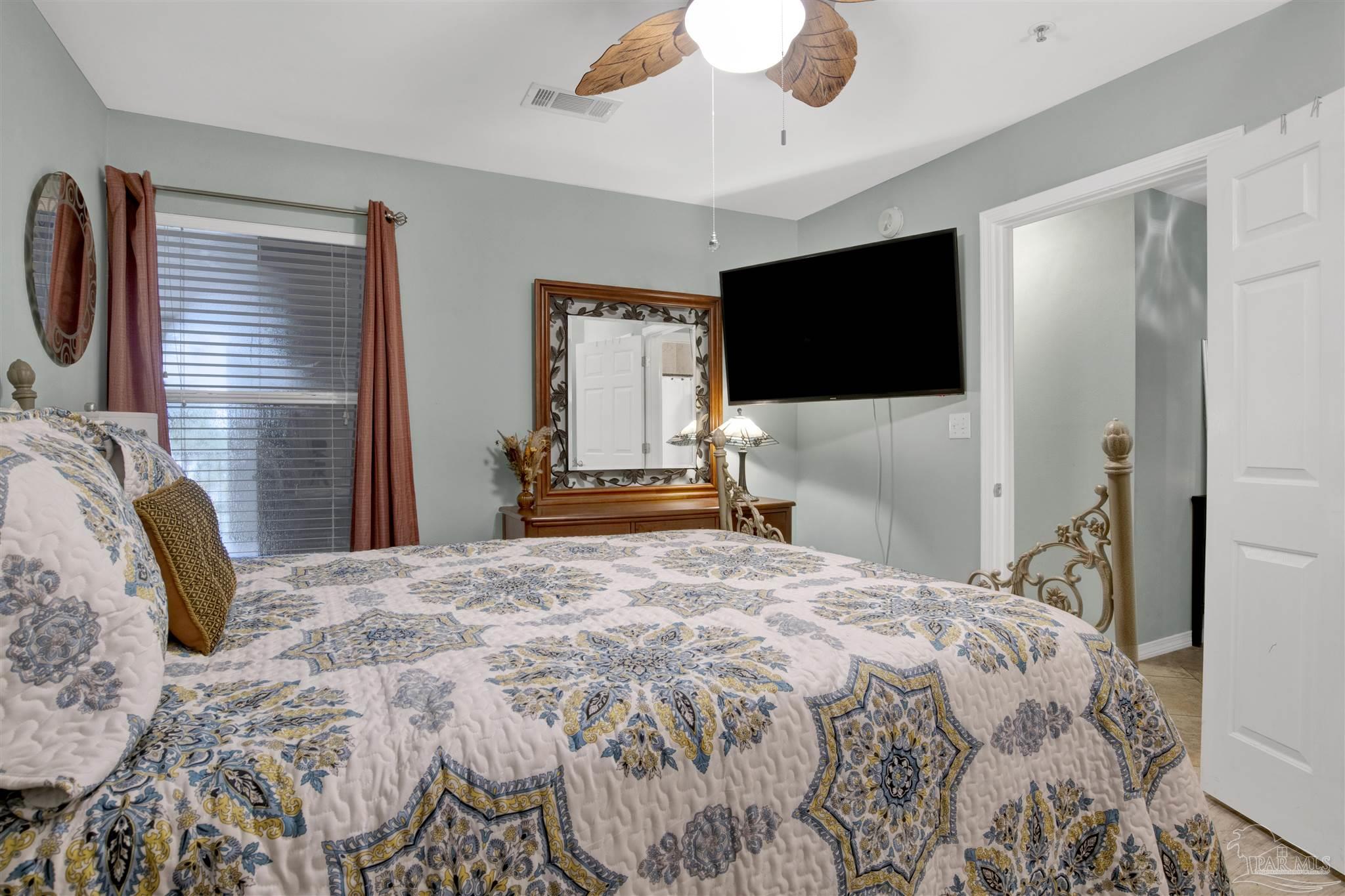 13351 Johnson Beach Road, Unit 203E Perdido Key, FL 32507 - Photo 21 of 55 a bedroom with a bed and a flat screen tv
