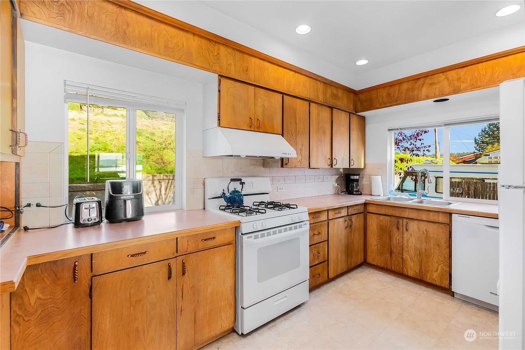 315 Shore Drive Bremerton, WA 98310 - Photo 16 of 38 a kitchen with stainless steel appliances granite countertop a stove a sink and a refrigerator