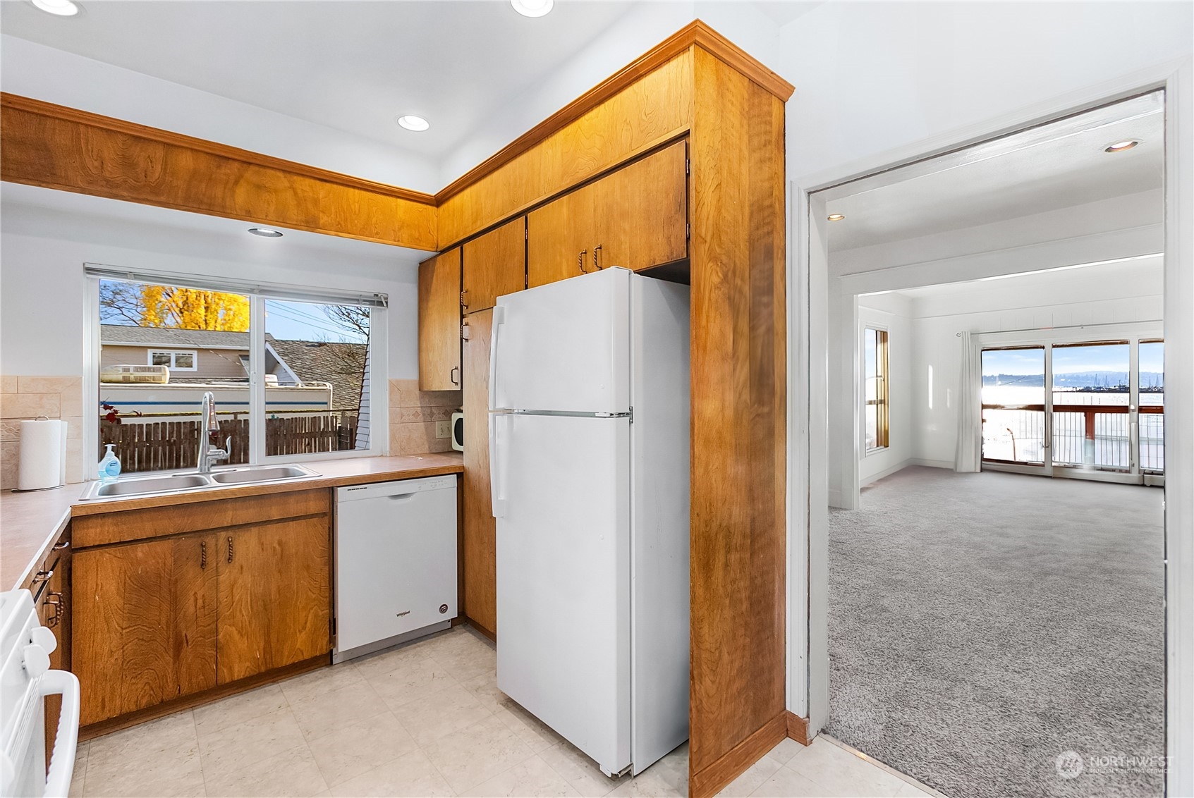 315 Shore Drive Bremerton, WA 98310 - Photo 17 of 38 a view of a hallway with a refrigerator and microwave