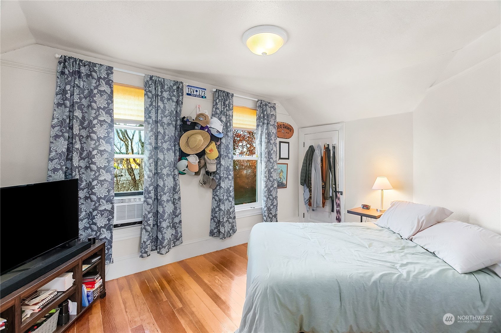315 Shore Drive Bremerton, WA 98310 - Photo 24 of 38 a bedroom with a bed and a flat tv screen on the dresser