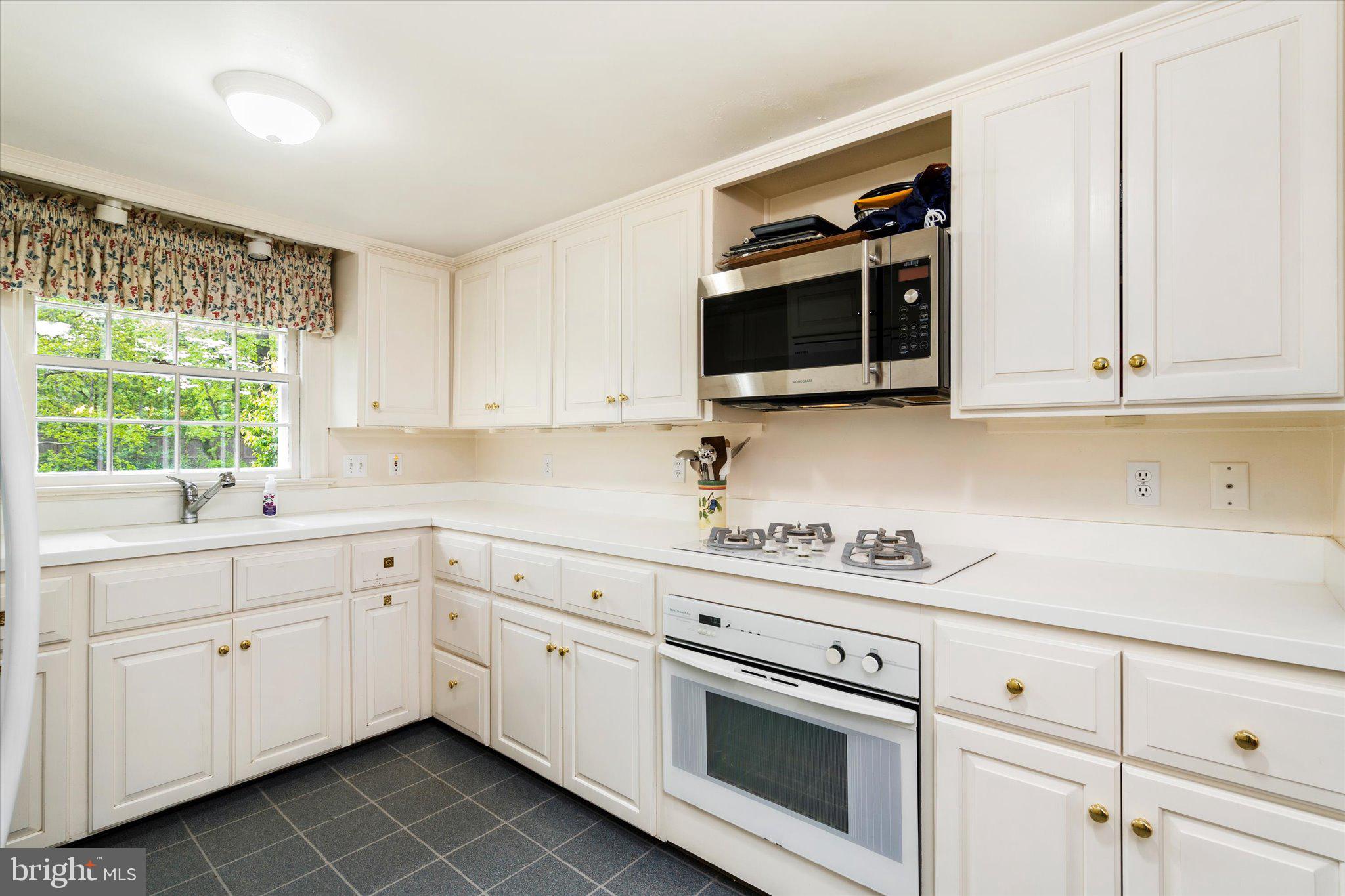 21 Elm Road Princeton, NJ 08540 - Photo 11 of 28 a kitchen with white cabinets stainless steel appliances and sink