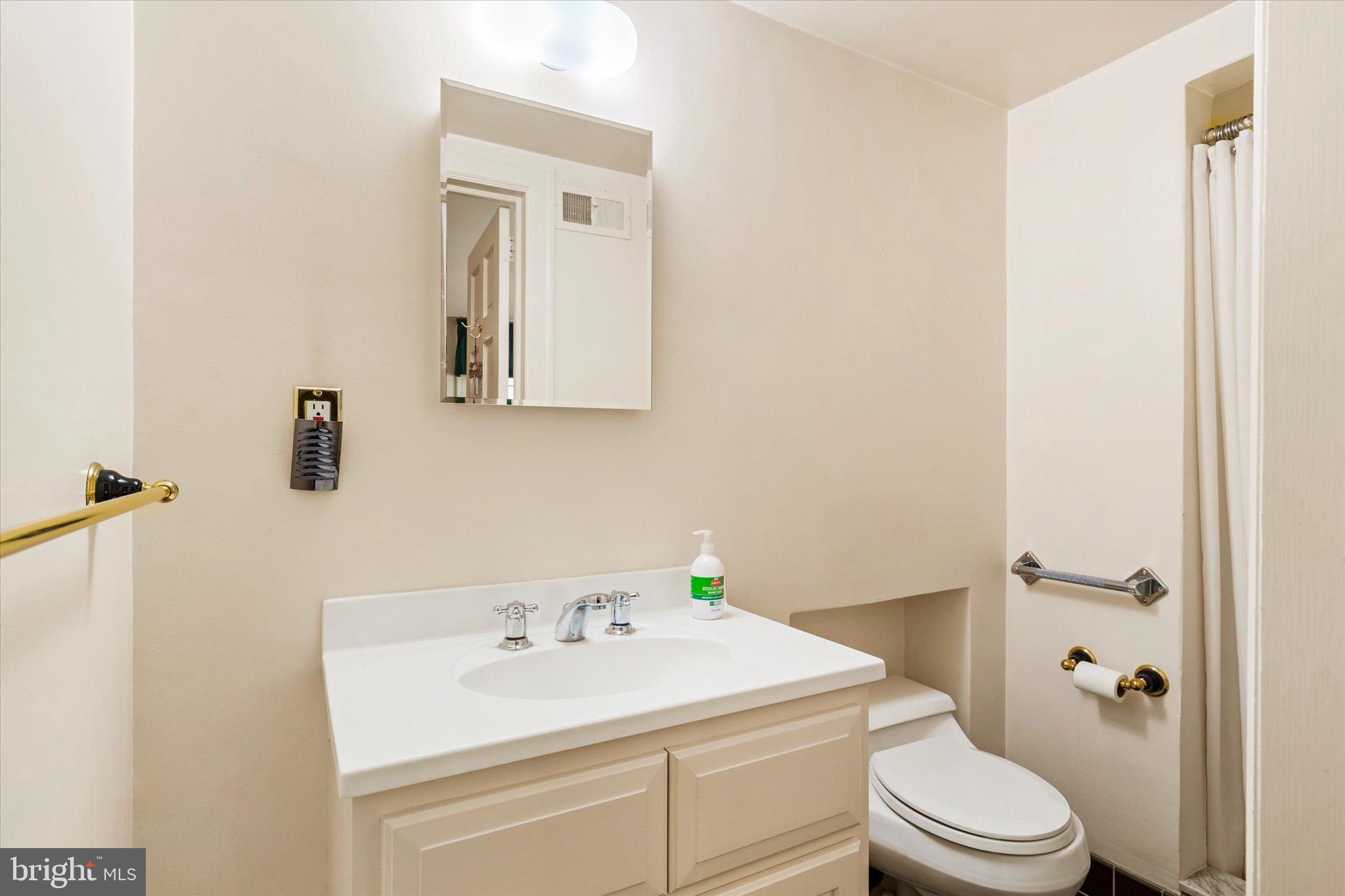 21 Elm Road Princeton, NJ 08540 - Photo 13 of 28 a bathroom with a sink toilet and mirror