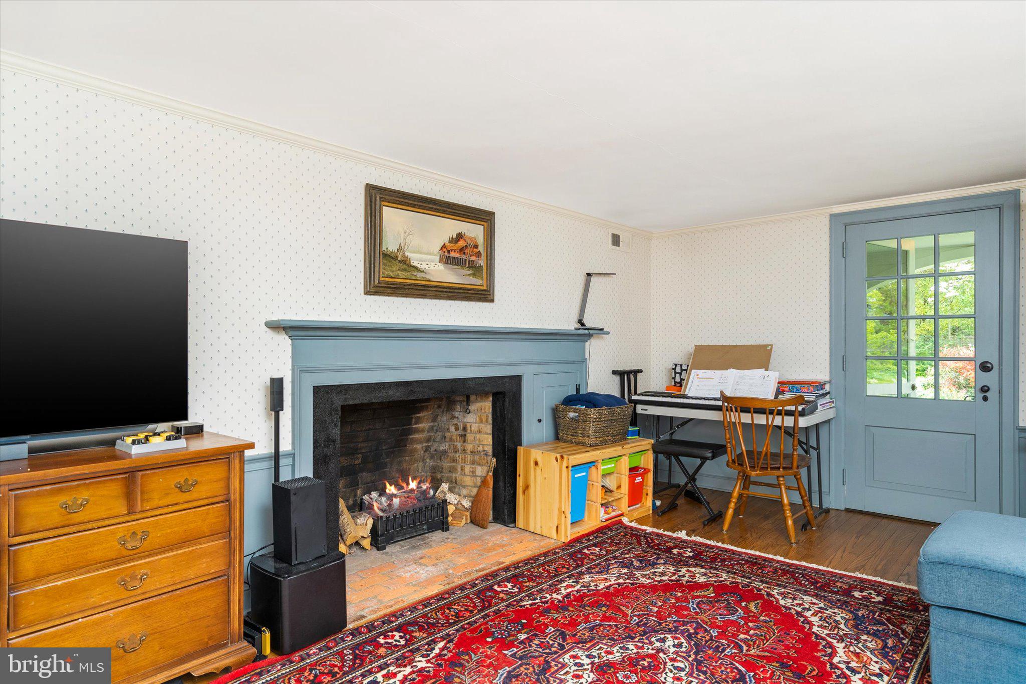 21 Elm Road Princeton, NJ 08540 - Photo 6 of 28 a livingroom with a fireplace and workspace