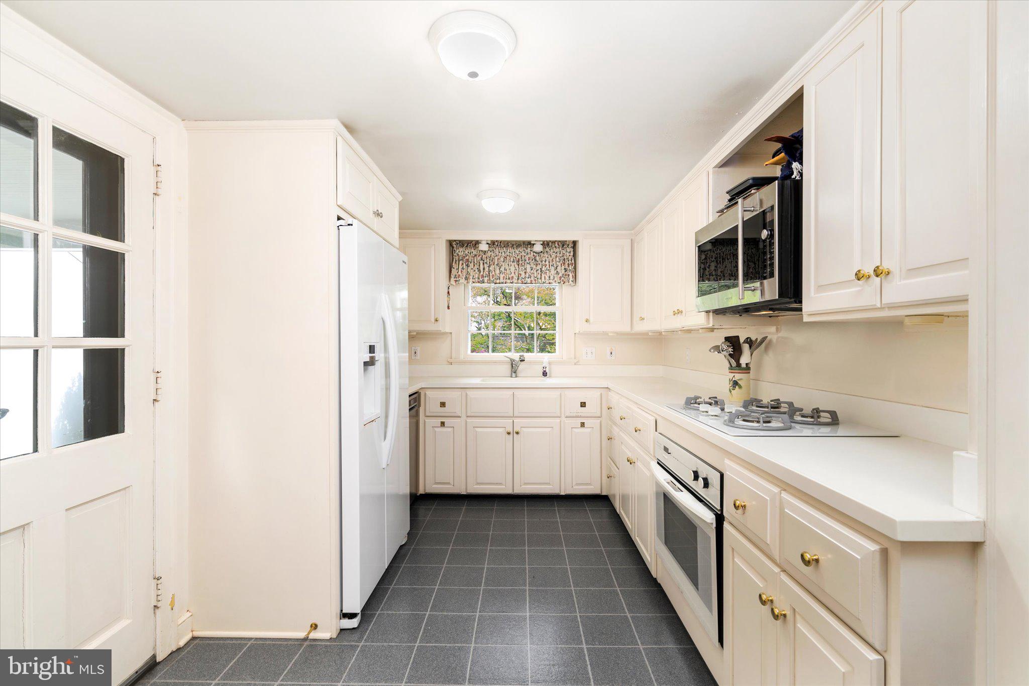 21 Elm Road Princeton, NJ 08540 - Photo 10 of 28 a kitchen with a sink stove and microwave
