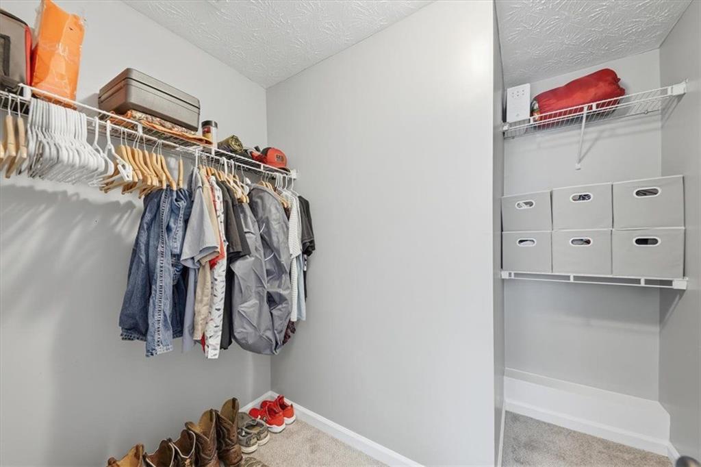 493 Youth Jersey Road Covington, GA 30014 - Photo 33 of 52 a view of walk in closet with clothes and shoes