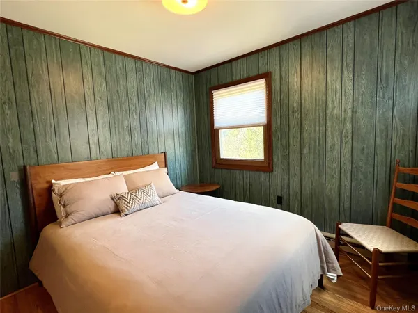 a bedroom with a bed and a window