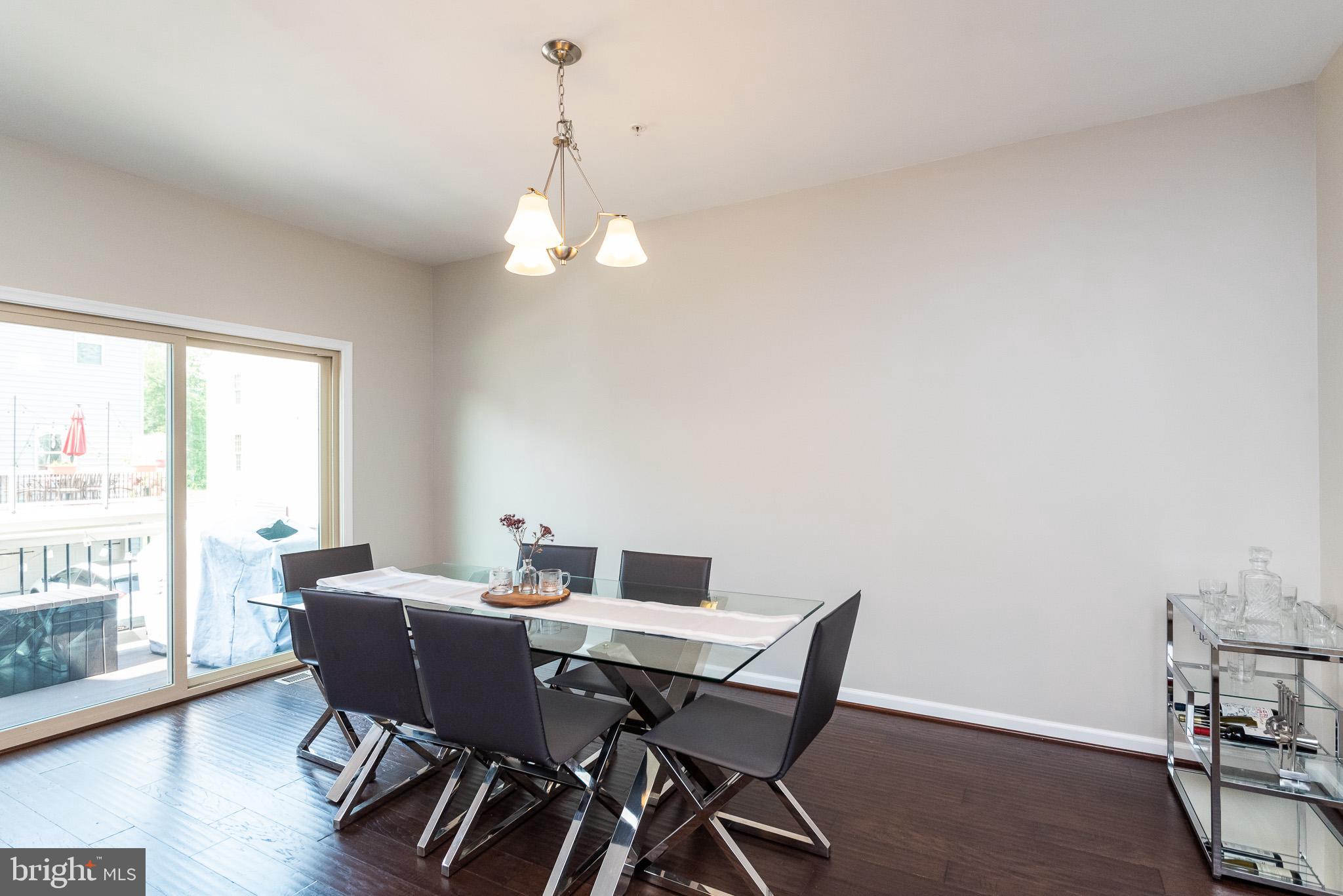 1038 Ramble Run Road Baltimore, MD 21220 - Photo 15 of 47 a view of a dining room with furniture window and wooden floor
