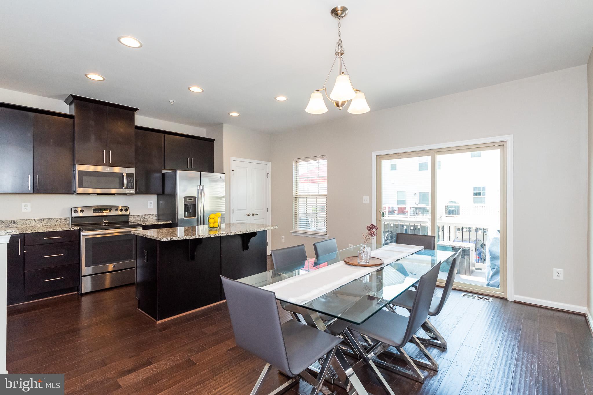 1038 Ramble Run Road Baltimore, MD 21220 - Photo 16 of 47 a large kitchen with a table and chairs