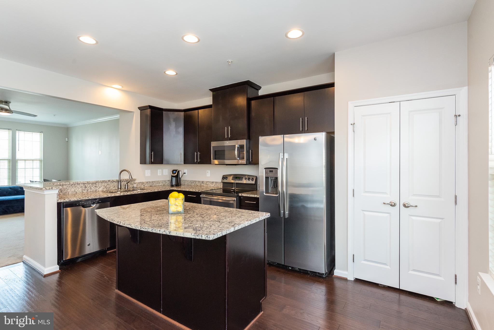 1038 Ramble Run Road Baltimore, MD 21220 - Photo 22 of 47 a kitchen with stainless steel appliances granite countertop refrigerator sink and stove