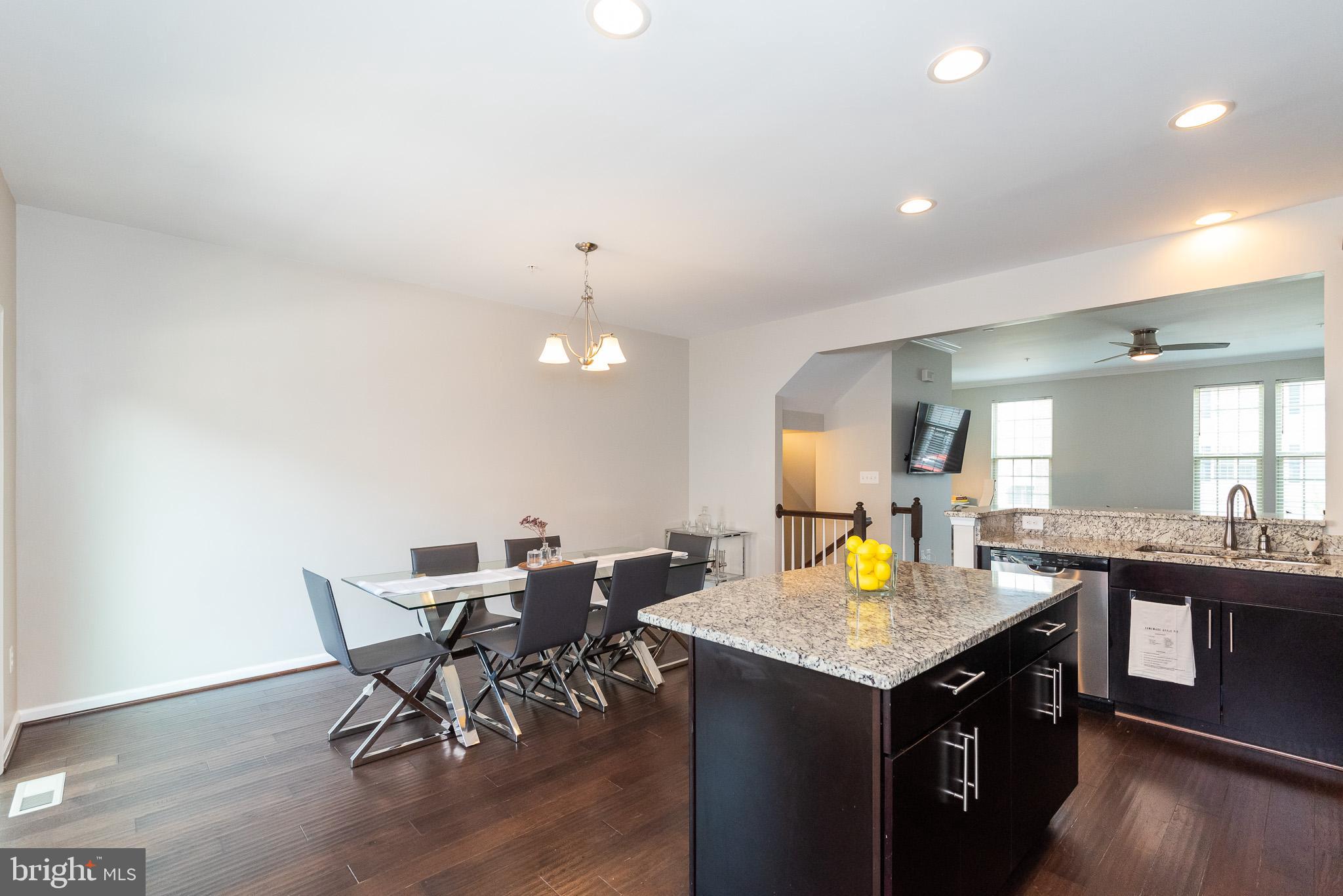 1038 Ramble Run Road Baltimore, MD 21220 - Photo 25 of 47 a kitchen with a table and chairs in it