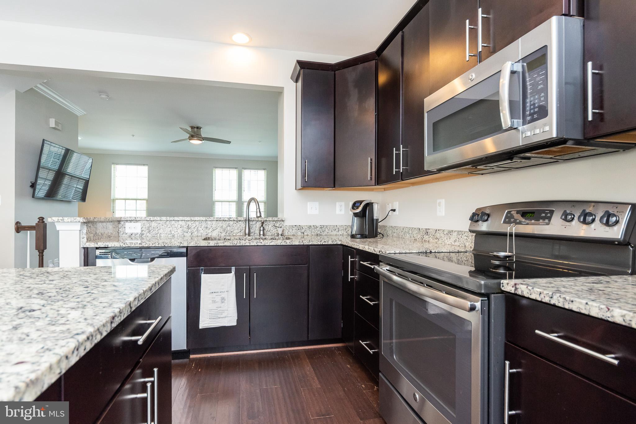 1038 Ramble Run Road Baltimore, MD 21220 - Photo 26 of 47 a kitchen with stainless steel appliances granite countertop a sink and stove