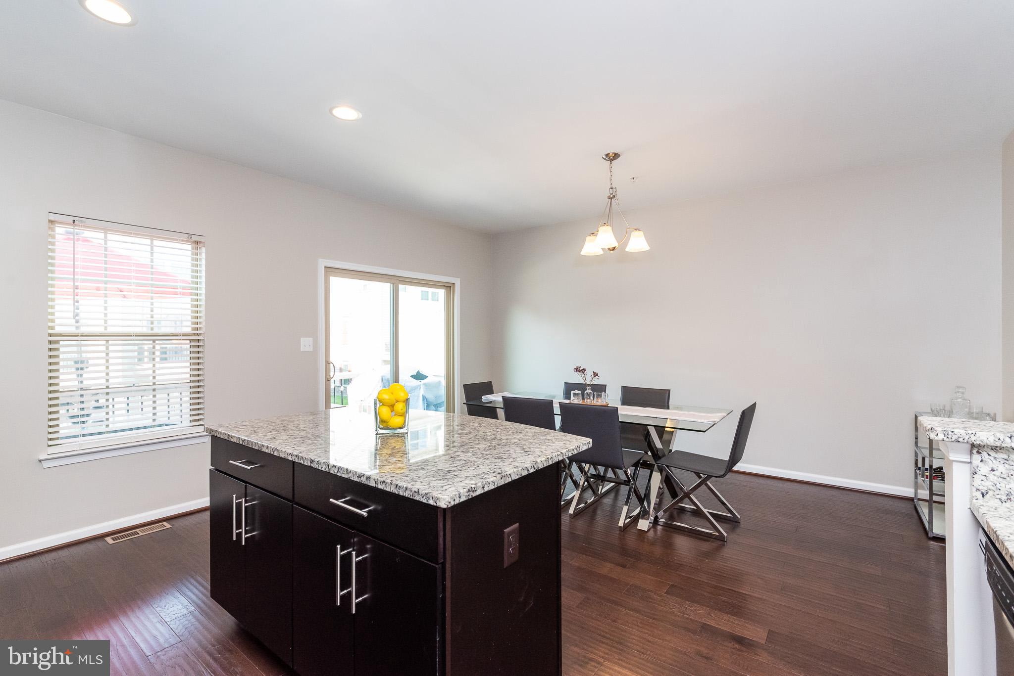 1038 Ramble Run Road Baltimore, MD 21220 - Photo 27 of 47 a view of a kitchen counter space dining table and wooden floor