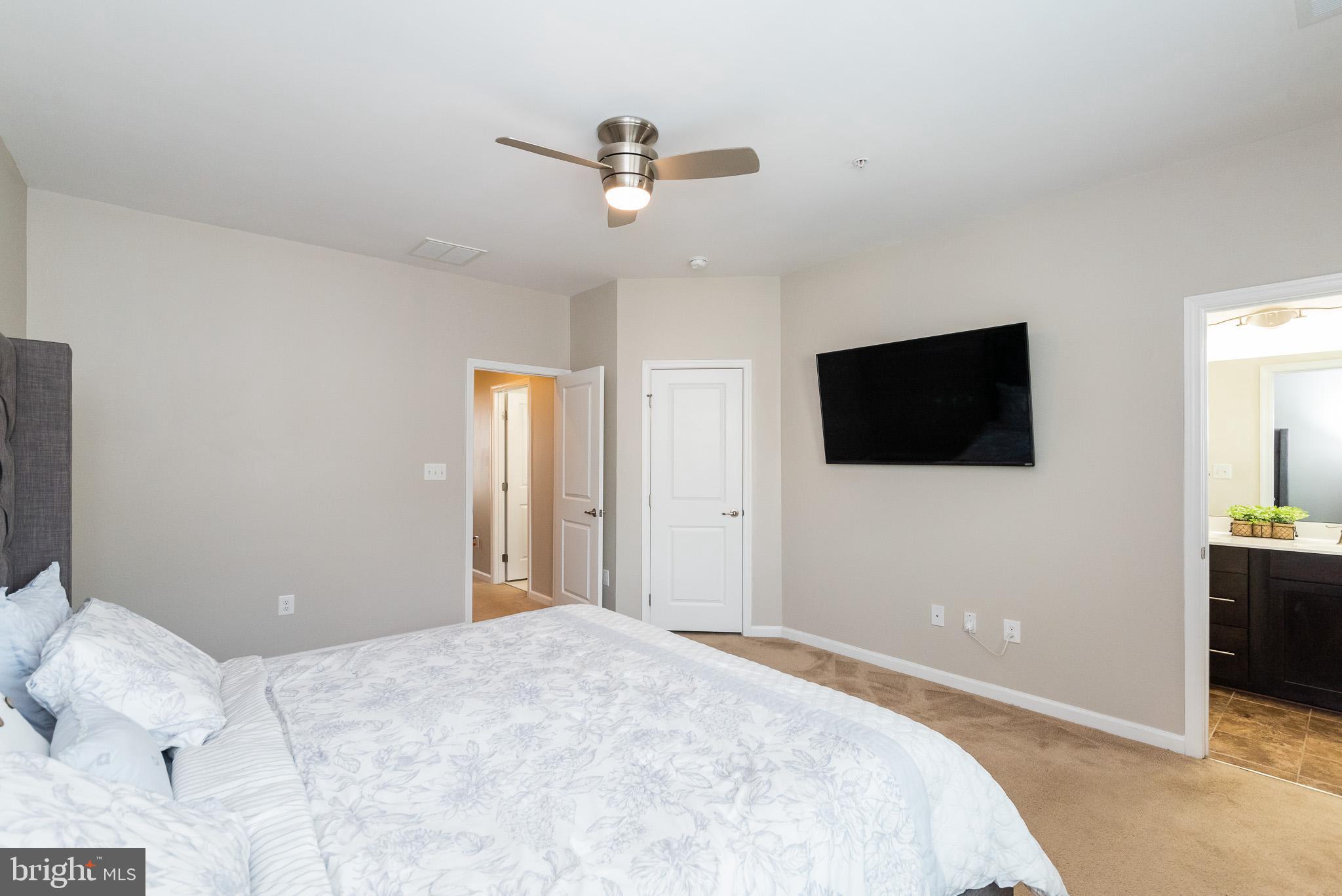 1038 Ramble Run Road Baltimore, MD 21220 - Photo 30 of 47 a bedroom with a bed and a flat screen tv