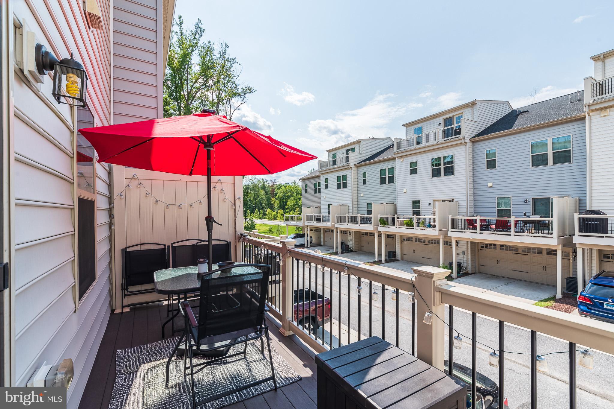 1038 Ramble Run Road Baltimore, MD 21220 - Photo 46 of 47 a view of a balcony with chairs and wooden floor